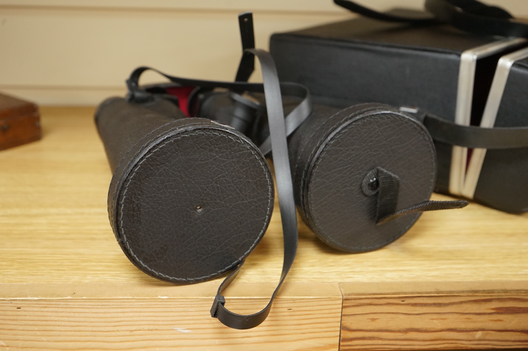 A cased pair of Vixen B Type 10x70 binoculars, stamped ‘Waterproof’, B4 Field 5.3 ‘92M at 1000M’, serial no. 303K050, with rubber shade guards, lens caps and integral tripod mounting, binoculars 27cm long, with the origi